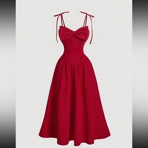 red flowy dress with skinny straps and cute bow detail on the bodice